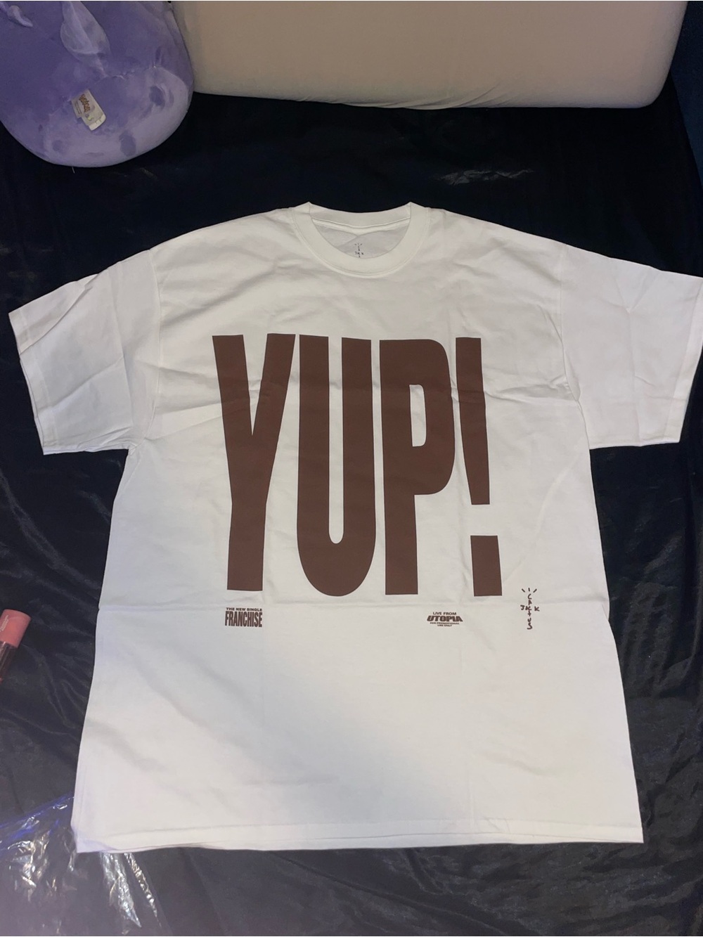 Travis Scott White T‑Shirt with Brown "YUP!" Graphic